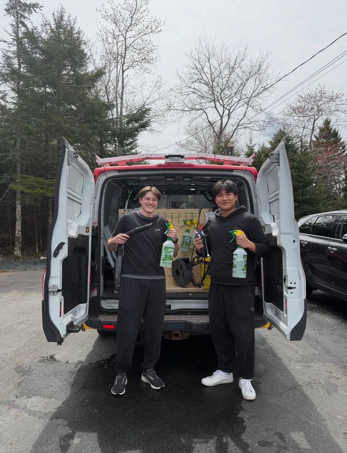 Austin and Woobin, founders of WCAP Mobile Car Detailing, standing in front of their mobile detailing van